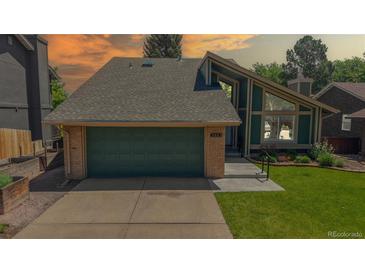 Charming two-story home featuring an attached two-car garage and landscaped front yard at 3883 S Fraser St, Aurora, CO 80014