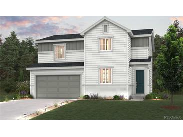 Charming two-story home with a gray two-car garage and landscaped front yard at 4284 Gozzer Ranch Dr, Elizabeth, CO 80107