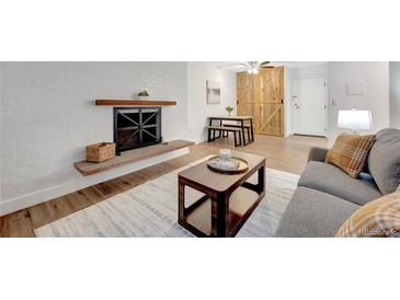 Inviting living room featuring a fireplace and stylish furnishings at 4110 Hale Pkwy Pkwy # 4J, Denver, CO 80220