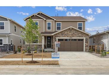 Charming two-story home with stone accents, a two-car garage, and a well-manicured lawn at 24748 E 40Th Ave, Aurora, CO 80019