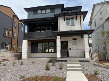 Modern two-story home boasting mixed siding, a covered porch, and professional landscaping at 7260 Waterleaf Trl, Littleton, CO 80125