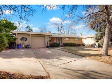 Charming single-story brick home with a well-maintained lawn and attached garage at 3311 S Dahlia St, Denver, CO 80222