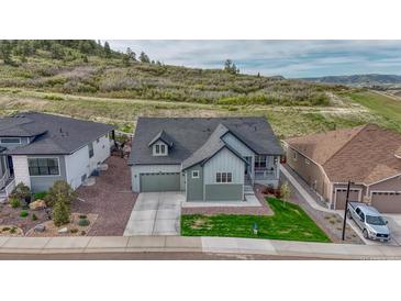 Beautiful two-story home with a two car garage, landscaped yard, and mountain views at 788 Alumroot St, Castle Rock, CO 80104
