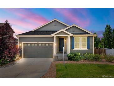 Charming single-Gathering home featuring a well-maintained lawn, attached garage and inviting entrance at 2043 S Cathay Way, Aurora, CO 80013