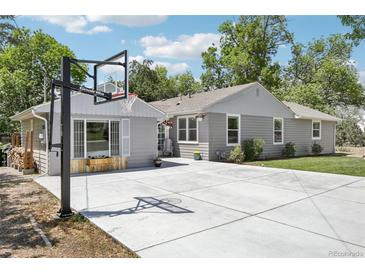Charming gray home featuring a basketball hoop and a spacious concrete driveway perfect for outdoor activities at 9630 W 38Th Ave, Wheat Ridge, CO 80033