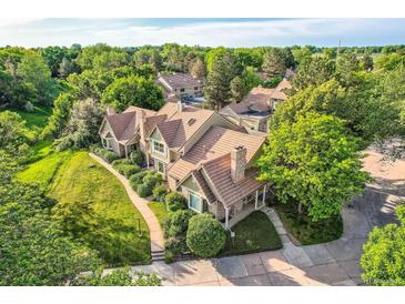 A beautiful exterior shot showcasing a well-maintained home surrounded by lush green trees at 2299 Ranch Dr, Westminster, CO 80234