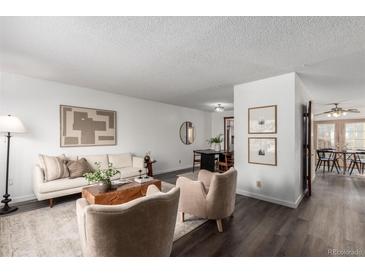 Cozy living room featuring modern furniture, stylish decor, and wood-look floors at 7484 E Princeton Ave, Denver, CO 80237