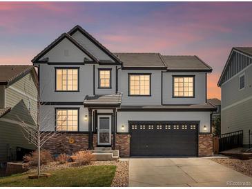 Charming two-story home boasting a well-manicured lawn, dark trim, and a spacious two-car garage at 2853 Black Canyon Way, Castle Rock, CO 80109