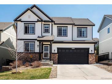 Charming two-story home with black trim, updated windows, brick accents, and a two-car garage at 2853 Black Canyon Way, Castle Rock, CO 80109