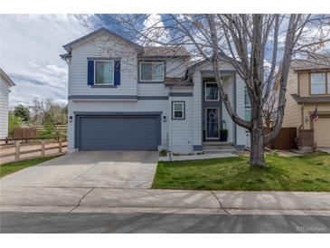 Charming two-story home featuring blue shutters, a well-kept lawn, and an attached two-car garage at 294 Willowick Cir, Highlands Ranch, CO 80129