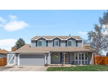 Charming two-story home with a well-manicured lawn and a two-car garage at 12945 E Colorado Ave, Aurora, CO 80012