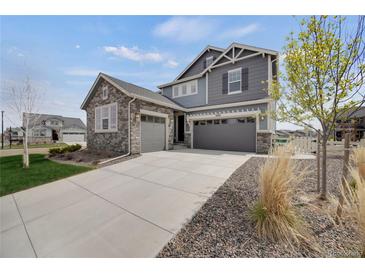 Charming two-story home with a three-car garage and stone accents at 6802 S Uriah St, Aurora, CO 80016