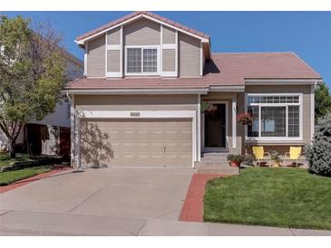 Charming two-story home with a well-maintained lawn and a two-car garage at 10057 Cedaridge Way, Highlands Ranch, CO 80129