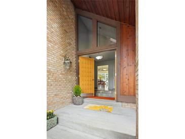 Inviting front entrance features a striking brick facade and unique architectural details at 10572 E Orchard Pl, Englewood, CO 80111