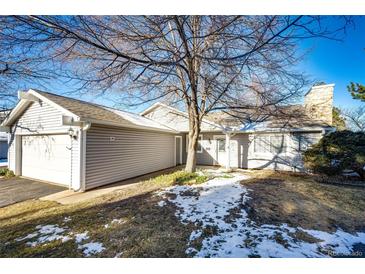 Gray exterior home with attached garage and small front yard at 14393 E Marina Dr, Aurora, CO 80014