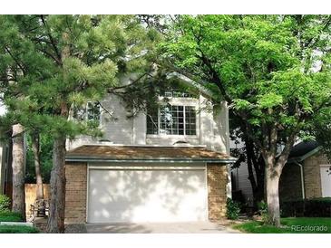 Two-story home with attached garage and mature trees at 2238 S Nile Ct, Aurora, CO 80014