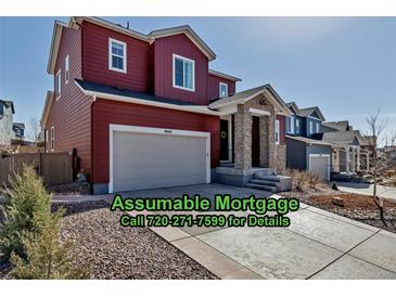 Charming two-story home featuring a two-car garage, stone pillar entry, and landscaped front yard at 4840 Point Mesa St, Castle Rock, CO 80108
