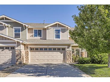 Charming two-story home featuring a two-car garage, stone accents, and manicured landscaping at 6187 Wescroft Ave, Castle Rock, CO 80104