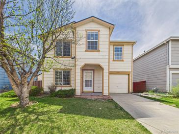 Charming two-story home boasts a well-manicured lawn and inviting curb appeal at 5010 E 100Th Dr, Thornton, CO 80229