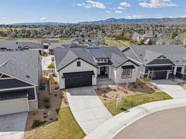 Stunning exterior with landscaped yard and mountain views in a desirable community at 6586 S Lewis Ct, Littleton, CO 80127