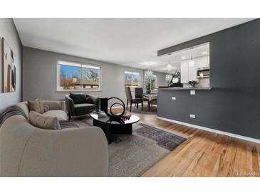 Inviting living room featuring an open layout, hardwood floors, and contemporary decor at 525 Jackson St # 304, Denver, CO 80206