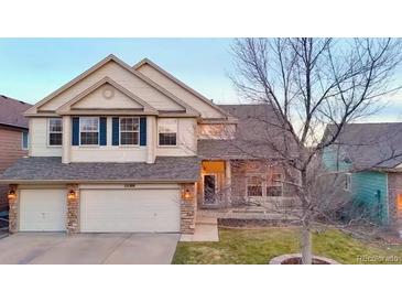 Charming two-story home featuring a stone-accented facade, two-car garage, and well-manicured lawn at 22388 Quail Run Dr, Parker, CO 80138
