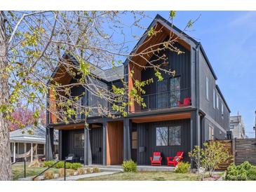 Modern black townhome with balconies and striking architectural details and lovely landscaping at 4454 Utica St, Denver, CO 80212
