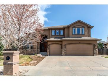Stunning two-story home boasts a 3-car garage and lush landscaping in a desirable neighborhood at 13970 Craig Way, Broomfield, CO 80020
