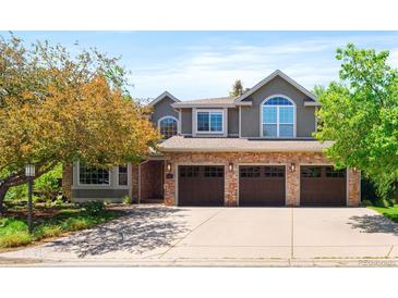 Charming two-story home with a three-car garage, brick accents, and manicured landscaping at 2345 Spotswood Pl, Boulder, CO 80304