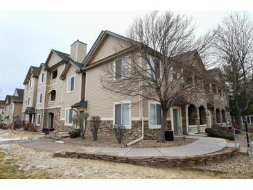 Beautiful condo with stone accents and manicured landscaping around the exterior at 8369 S Independence Cir # 205, Littleton, CO 80128