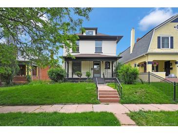Charming two-story home featuring a welcoming front porch and well-maintained lawn at 2411 N High St, Denver, CO 80205