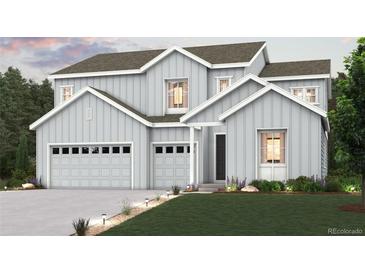 Charming two-story home featuring board and batten siding, attached garage, and beautifully landscaped front yard at 2525 Lupton Ln, Lafayette, CO 80026