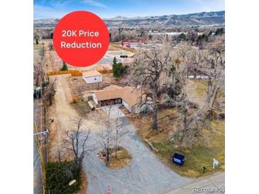 Sprawling property with mature trees and mountain views featuring a recent price reduction at 14290 W 54Th Ave, Arvada, CO 80002
