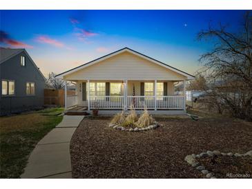 Charming home featuring a cozy front porch and well-maintained landscaping at 2019 S Fox St, Denver, CO 80223