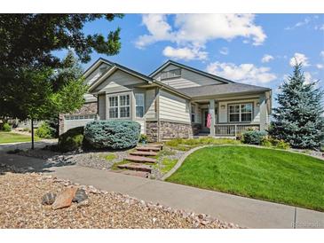 Charming home featuring a well-manicured front yard, stone accents, and inviting porch at 23545 E Phillips Pl, Aurora, CO 80016