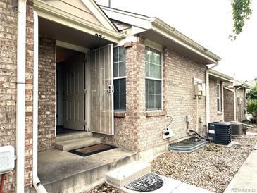 Charming brick home with a welcoming front entrance featuring a storm door for added security at 1470 S Quebec Way # 275, Denver, CO 80231