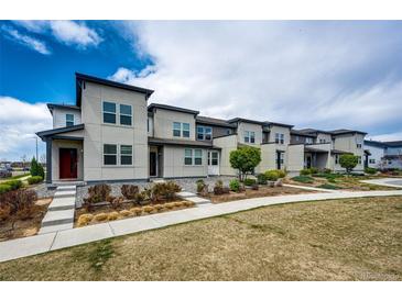 Modern townhome exterior featuring a landscaped front yard and contemporary architectural details at 16075 E Elk Pl, Denver, CO 80239