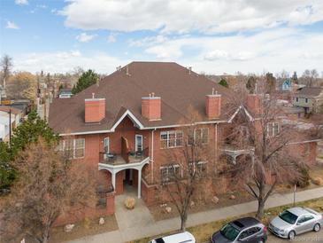 View of the brick exterior featuring multiple chimneys and a balcony at 4001 W 32Nd Ave # 1, Denver, CO 80212