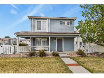 Charming two-story home with a covered porch and well-maintained front yard at 21422 E 47Th Ave, Denver, CO 80249
