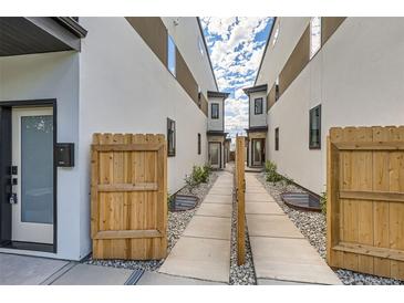 Modern townhouse exterior with private gated walkway and landscaping at 1717 Grove St, Denver, CO 80204