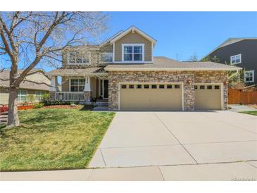 Charming two-story home featuring a three-car garage, stone accents and a well-manicured lawn at 3754 Broadview Pl, Castle Rock, CO 80109