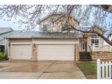 Charming two-story home with a three-car garage and a covered front porch at 329 Lodgewood Ln, Lafayette, CO 80026