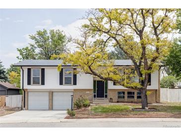 Charming home featuring a well-maintained yard, a two-car garage, and a classic exterior design at 12680 W 38Th Dr, Wheat Ridge, CO 80033