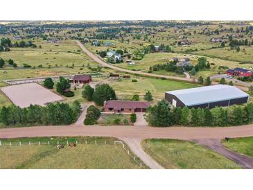 Aerial view of horse property featuring paddocks and training area at 10325 Cherrywood Dr, Parker, CO 80138