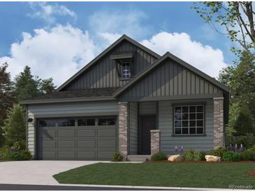 Charming home featuring vertical siding, brick accents, and a well-manicured lawn at 13826 Honey Hush Trl, Parker, CO 80134