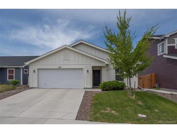 Charming single-Gathering home featuring a well-maintained lawn and an attached two-car garage at 653 S Hoover Ave, Fort Lupton, CO 80621