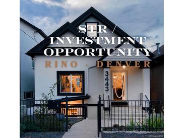 Charming two-story home featuring black and white trim, inviting entrance, and well-maintained landscaping at 3443 Lawrence St, Denver, CO 80205