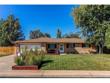 Brick ranch home with attached garage, landscaped lawn, and mature trees at 867 S Everett St, Lakewood, CO 80226