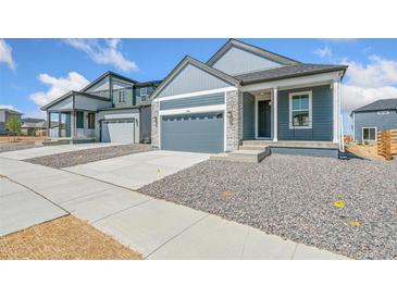 Charming two-story home with stone accents and well-maintained gravel landscaping at 9343 Biscay St, Commerce City, CO 80022