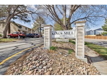 Kings Mill community sign featuring manicured rock landscaping and parking visible behind at 8915 Field St # 118, Broomfield, CO 80021